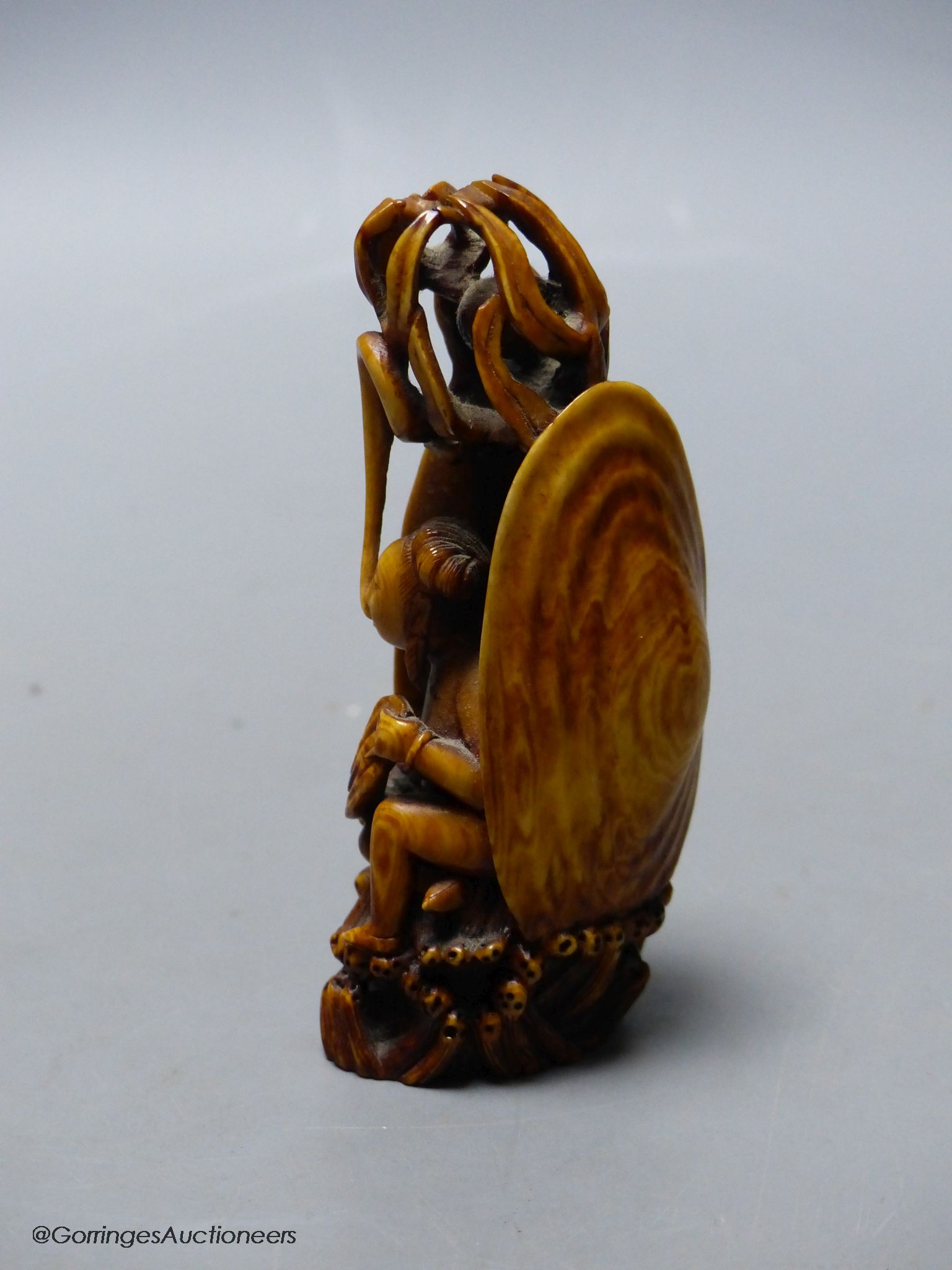 A Chinese ivory figure of a woman in a clam shell, 19th century